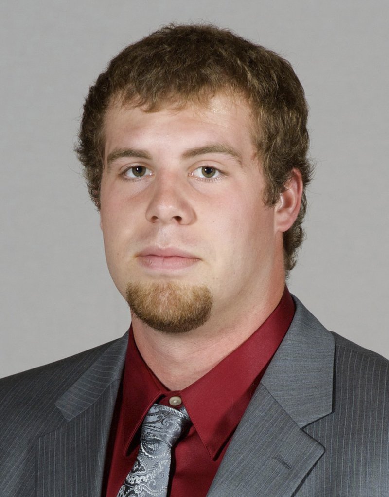 In this undated photo, provided by Southern Illinois University, Jason Seaman, a defensive end for the SIU football team, poses for a photo in Carbondale, Ill. Seaman, now a science teacher at Noblesville West Middle School in Noblesville, Ind., subdued a student armed with two handguns who opened fire inside his classroom Friday, May, 25, 2018. (Southern Illinois University via AP)