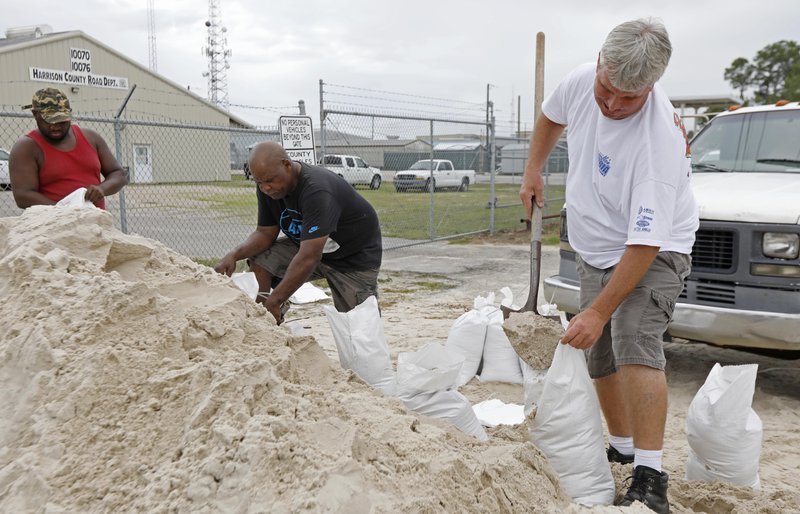 Gulfport, Miss., residents shovel sand into bags at a Harrison County Road Department sand bagging location, while preparing for Subtropical Storm Alberto to make its way through the Gulf of Mexico, Saturday, May 26, 2018. The slow moving storm is threatening to bring heavy rainfall, storm surges, high wind and flash flooding this holiday weekend. (AP Photo/Rogelio V. Solis)