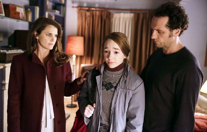 Elizabeth Jennings (Keri Russell) lies to her daughter, Paige (Holly Taylor), while her conscience-beset husband, Philip (Matthew Rhys), goes along in The Americans. The FX series ends Wednesday. 
