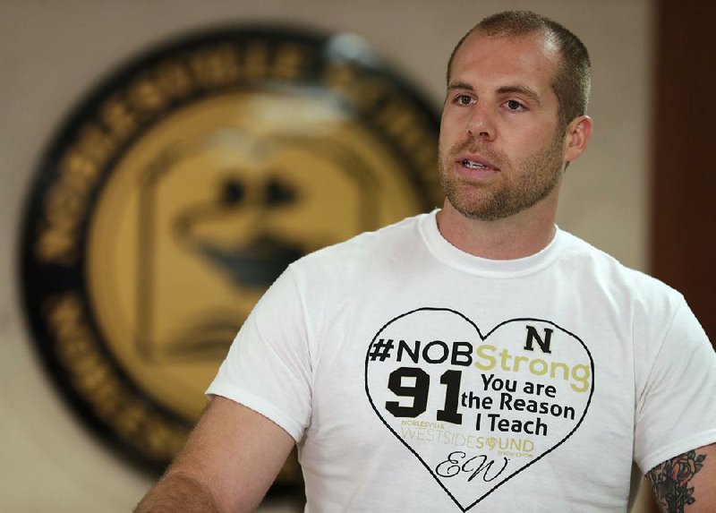 Jason Seaman, a seventh grade science teacher at Noblesville West Middle School in Noblesville, Ind., speaks during a news conference Monday, May 28, 2018. Seaman tackled and disarmed a student with a gun at the school on Friday. He was shot but not seriously injured. 