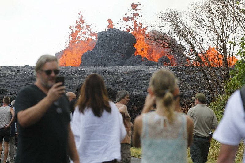 Hawaii residents, the media and national guardsmen flock to what is now the end of Leilani Avenue to take in the fiery show at fissures 2, 7 and 8 of the Kilauea volcano near Pahoa, Hawaii. 
