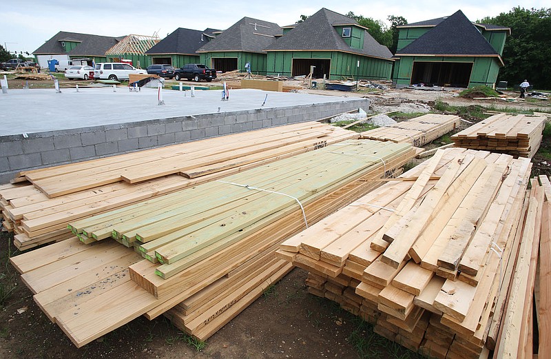 Construction continues on houses near the intersection of West Tuscan and North Malbec Roads in Fayetteville in this Wednesday, May 23, 2018, file photo. (NWA Democrat-Gazette/DAVID GOTTSCHALK)