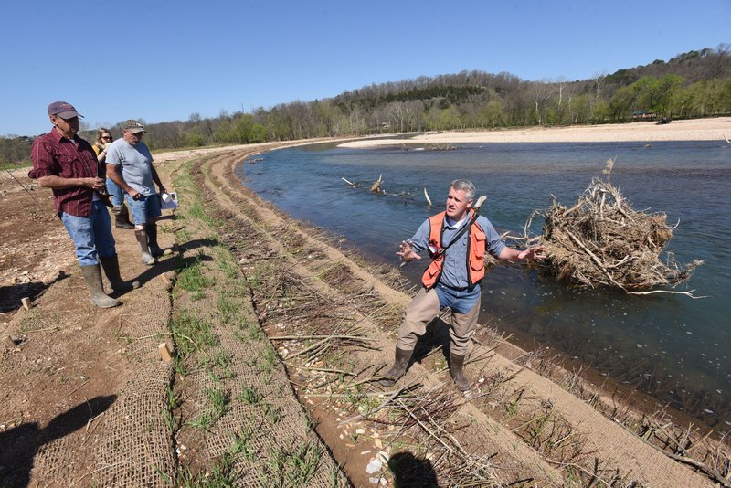 Steve Herrington with The Nature Conservancy talks last month about the Elk River stream bank restoration project completed one mile upstream from Noel, Mo. A bend in the river had severe erosion problems that polluted the stream with silt and caused property owners to lose land. 