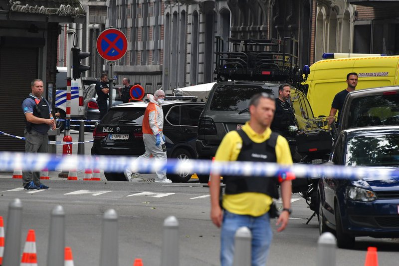 Police investigate at the scene of a shooting in Liege, Belgium, Tuesday, May 29, 2018. A gunman killed three people, including two police officers, in the Belgian city of Liege on Tuesday, a city official said. Police later killed the attacker, and other officers were wounded in the shooting.(AP Photo/Geert Vanden Wijngaert)