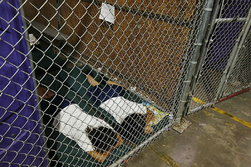 This photo of two female detainees sleeping in a holding cell in Nogales, Ariz., is one of several taken in 2014 that activists used as examples of current immigration policies. 