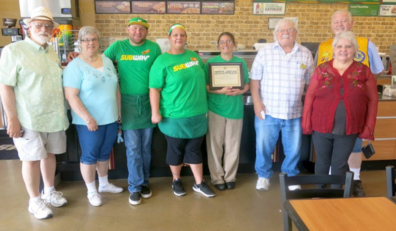 Westside Eagle Observer/SUSAN HOLLAND Members of the Gravette Lions Club visit the Gravette Subway sandwich shop following their May 15 club meeting to honor general manager Melissa Alley and her employees. They presented Alley and crew with a certificate in appreciation for their hospitality, great service and willingness to accommodate Lions Club meetings and their contributions to the club's Miles of Pennies fundraising campaign. Pictured are Lion Jeff Davis (left), Lion Sue Rice, Subway employees James Taylor and Heather Niefeld, general manager Melissa Alley, Lions Bill Mattler, Al Blair and Melissa Williams.