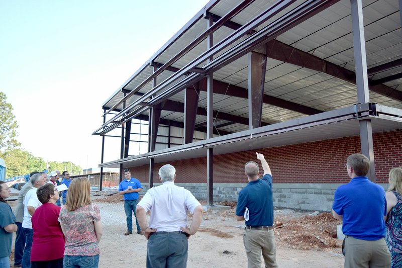 Westside Eagle Observer/MIKE ECKELS Members of the Decatur School Board get an update on the construction of the new middle school gym prior to the regular board meeting in the Decatur Middle School media center May 14.