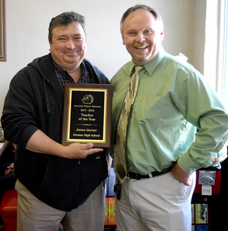 Westside Eagle Observer/MIKE ECKELS James Garner receives the Decatur High School Teacher of the Year award from Toby Conrad during the end-of-school-year banquet at the Gallery Cafe in Decatur May 17.