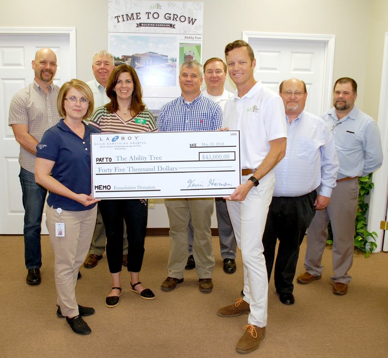 Janelle Jessen/Herald-Leader La-Z-Boy Foundation presented a $45,000 check to Ability Tree on Wednesday morning. Pictured, from left, are Rod Reed, Ability Tree board chairman; Audra Farrell, La-Z-Boy human resources manager; Mike Wilmon, La-Z-Boy production manager; Amy Dunn, Ability Tree director of family and team member relations; Paul Dilbeck, La-Z-Boy quality manager; Neil Erter, La-Z-Boy logistics manager; Joe Butler, Ability Tree director; Rick Wilmoth, La-Z-Boy controller; and Jeff McGarrah, La-Z-Boy materials manager.