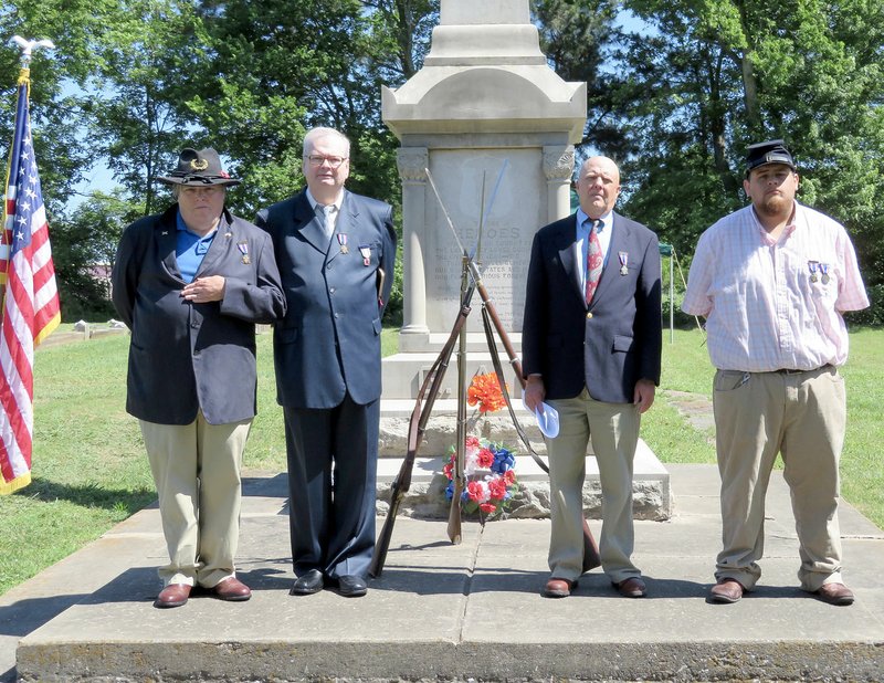 Westside Eagle Observer/RANDY MOLL Sons of Union Veterans Bob Underdown of Elm Springs, chaplain Clint Willis of Siloam Springs (also chaplain for Sons of Confederate Veterans), company commander Joe Rainey and Christopher Bribiesca Jr. of Bentonville were part of a redidication ceremony on Saturday, May 26, 2018, at the Grand Army of the Republic monument in Gentry Cemetery which was originally built by David Kost and dedicated by former Union and Confederate soldiers in 1918. The monument was recently added to the National Register of Historic Places.