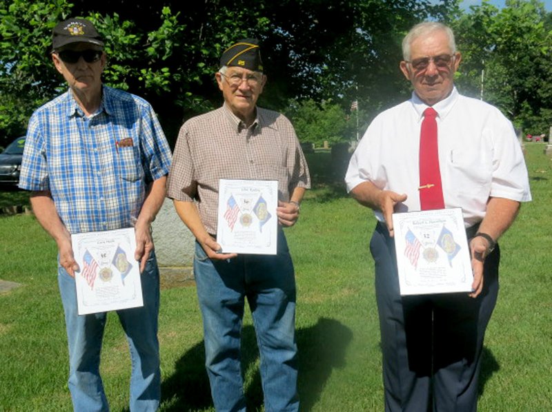 Westside Eagle Observer/SUSAN HOLLAND Three members of the John E. Tracy American Legion Post at Gravette display continuous membership certificates they received at the annual Memorial Day service at Hillcrest Cemetery. Navy veteran Gary Hook (left) has been a member 35 years; Army veteran John Easley, 36 years; and Army veteran Robert L. Hamilton 32 years. Also honored were Robert Honderich, 32 years; and Larry Holloway, 40 years.