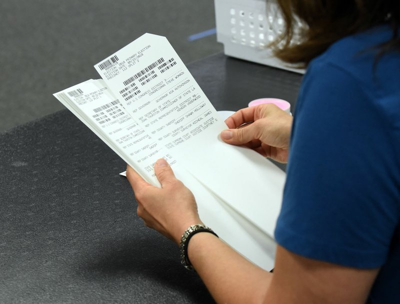  Ballots are recounted by hand at the Benton County Election Commission office in Rogers.