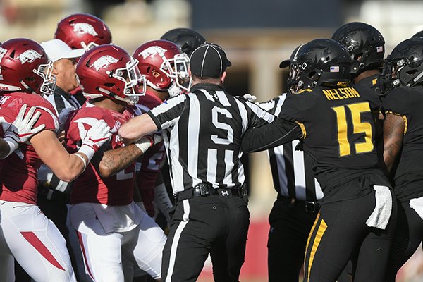Arkansas and Missouri players are separated by officials during a game Friday, Nov. 25, 2017, in Fayetteville. Arkansas and Missouri players are separated by officials during a game Friday, Nov. 25, 2017, in Fayetteville.