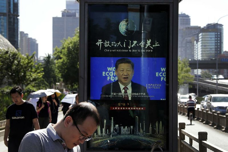An electronic panel in Beijing shows video of Chinese President Xi Jinping speaking Wednesday at the World Economy Forum. U.S. Commerce Secretary Wilbur Ross is to travel to China this weekend for trade-dispute talks. 
