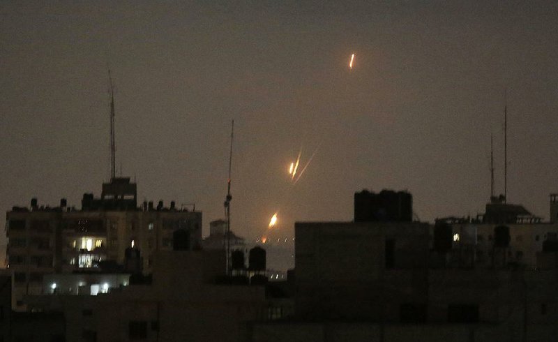 Rockets fired by Palestinian militants blaze over the Gaza Strip toward Israeli lands Wednesday. 