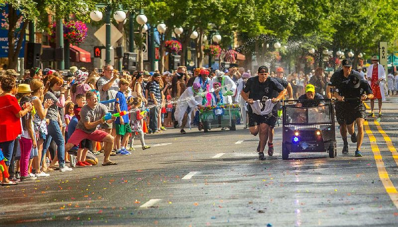Audience participation with cheers, water balloons and water guns are a big part of Stueart Pennington’s World Championship Running of the Tubs in downtown Hot Springs. 

