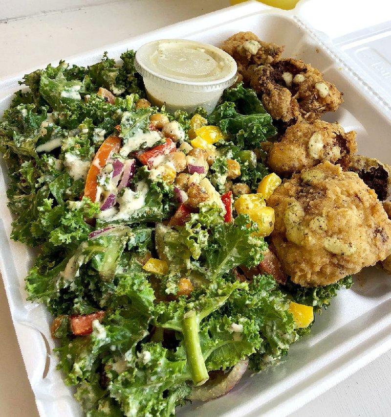 A heaping portion of Kale Salad With Cajun Chickpeas comes with a side, in this case batter-fried cauliflower.  