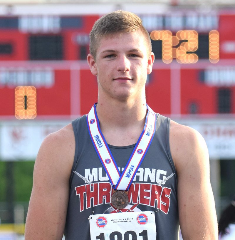 Rick Peck/Special to McDonald County Press Peyton Barton on the medal stage at the Missouri Class 4 State Track and Field Championships after getting his fifth-place medal.