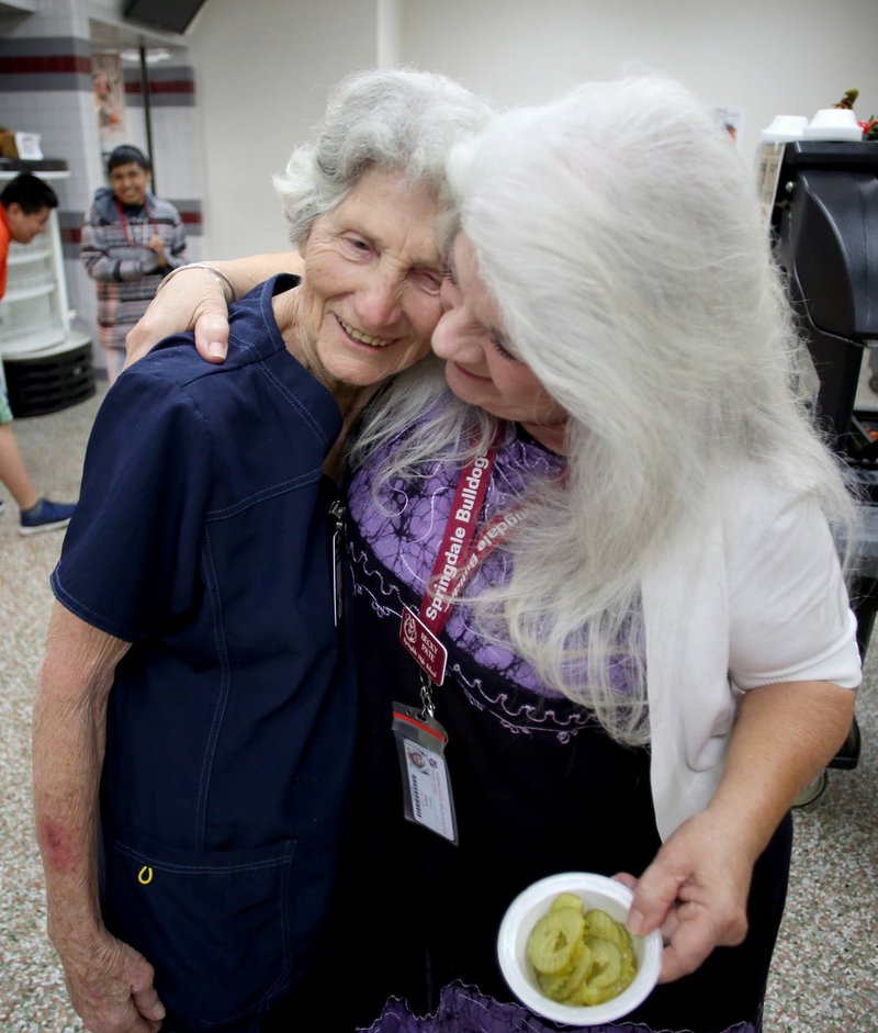 NWA Democrat-Gazette/DAVID GOTTSCHALK Delores Byers (left) receives a hug from Becky Pate, an instructional assistant at Springdale High School. Byers served Pate lunch while she was a student at Lee Elementary, Central Junior High and Springdale High School.