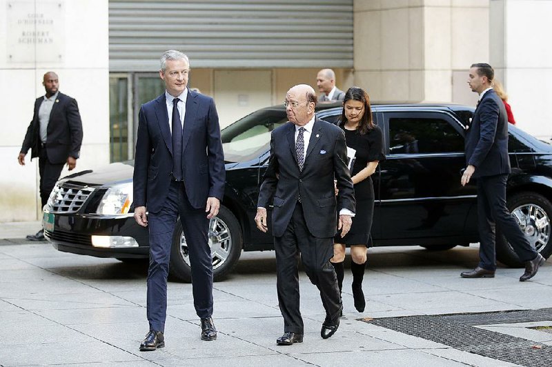 French Finance Minister Bruno Le Maire (left) welcomes U.S. Secretary of Commerce Wilbur Ross ahead of their Thursday meeting in Paris. Ross said talks with the Europeans about U.S. tariffs on European steel and aluminum were not successful enough to warrant a permanent exemption. 