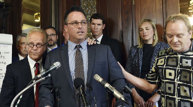 Supported by attorney Jeff Anderson (left), sexual abuse survivor Jim Keenan discusses the settlement reached Thursday between clergy abuse victims and the Archdiocese of St. Paul and Minneapolis. 