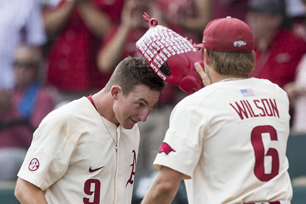 Hunter Wilson of Arkansas places the home run hog hat on Jax Biggers after he hit a two-run homer in the 6th inning against Oral Roberts Friday, June 1, 2018, during game one of the NCAA regional at Baum Stadium. Arkansas won 10-2.