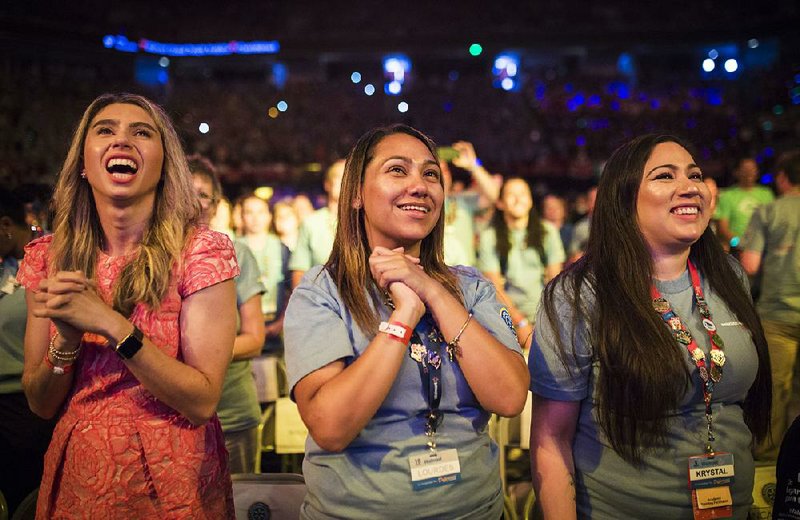 Jenny Fleiss, (left) chief executive of Walmart’s concierge service Jetblack, and Walmart employees Lourdes Garcia and Krystal Rivas attend festivities Friday at Bud Walton Arena in Fayetteville. 