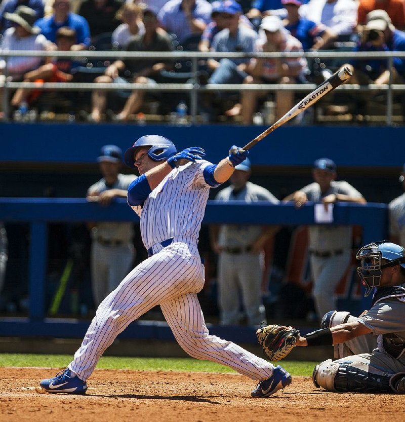 Florida’s Jonah Girand follows through on a two-run home run in the seventh inning against Columbia during an NCAA Division I baseball regional Friday in Gainesville, Fla. The home run extended the Gators’ lead to 10-4 as they went on to win 13-5. 