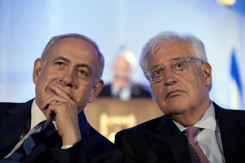 FILE - In this May 21, 2017, file photo, Israeli Prime Minister Benjamin Netanyahu, left and David Friedman, right, the new United States Ambassador to Israel attend a ceremony celebrating the 50th anniversary of the liberation and unification of Jerusalem, in front of the walls of the Old City of Jerusalem.  (Abir Sultan/Pool Photo via AP, File)