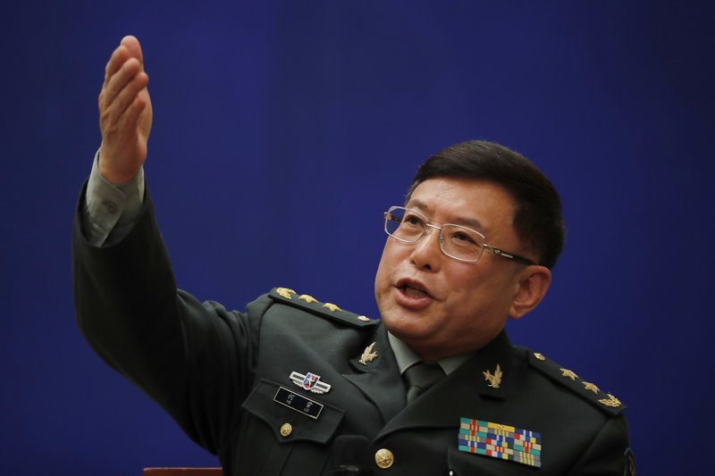FILE - In this March 8, 2018 file photo, Vice President of China's Academy of Military Sciences, Lt. Gen. He Lei gestures as he speaks during a press conference on the sidelines of the National People's Congress at the State Council Information Office in Beijing. China has dispatched a low-level military delegation to an annual security conference in Singapore that has dwelled heavily on Chinese activities in the South China Sea. (AP Photo/Andy Wong, File)