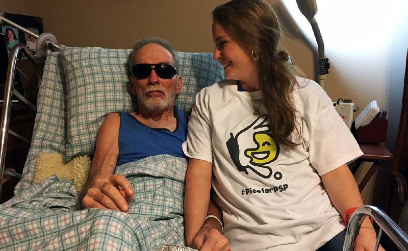 Randi Haley sits with her father, Tommy Harris, at his home in Hope late last month. Harris was diagnosed with progressive supranuclear palsy in 2013.  