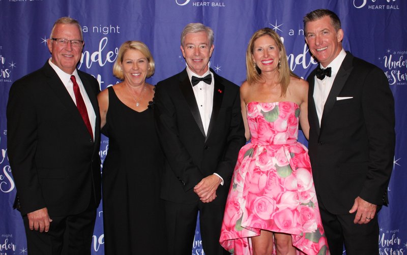 NWA Democrat-Gazette/CARIN SCHOPPMEYER American Heart Association Board President Chuck and Suzy Fehlig (from left), Heart Ball co-host Ed Morgan and co-host Julie and Keith Barber welcome guests to the benefit May 12 at the John Q. Hammons Center in Rogers.