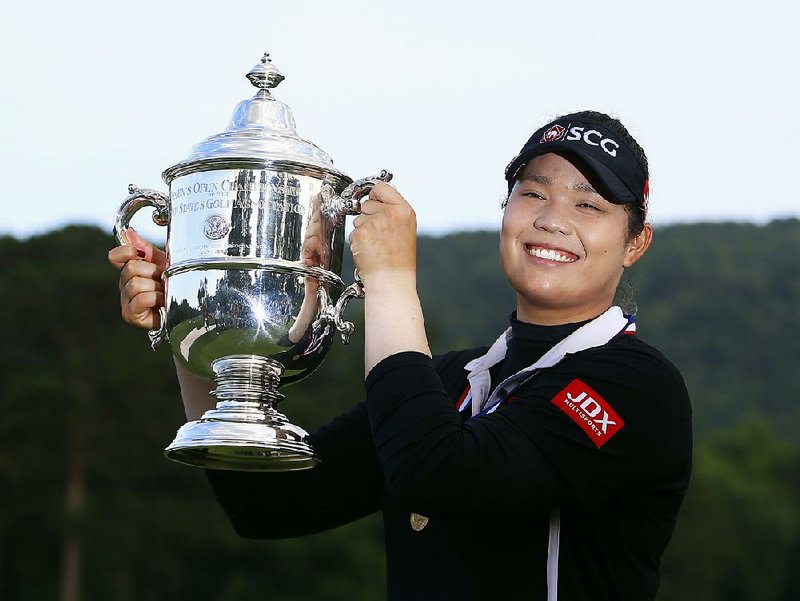 Ariya Jutanugarn, of Thailand, holds up the trophy after winning in a four hole playoff during the final round of the U.S. Women's Open golf tournament at Shoal Creek, Sunday, June 3, 2018, in Birmingham, Ala.