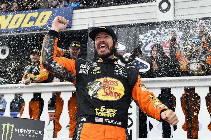 Martin Truex Jr. celebrates in Victory Lane after winning a NASCAR Cup Series auto race Sunday, June 3, 2018, in Long Pond, Pa. 