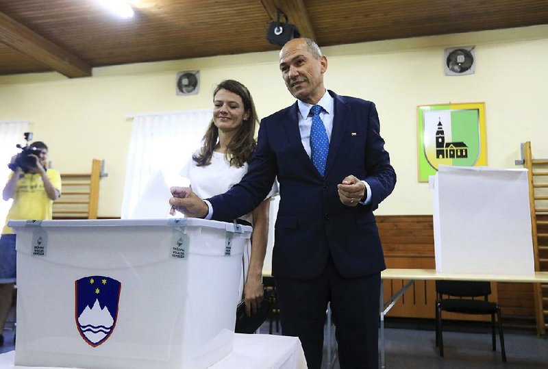 Janez Jansa, leader of the rightist Slovenian Democratic Party, casts his parliamentary election ballot Sunday at a polling station in Ljubljana. 
