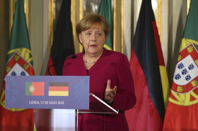 German Chancellor Angela Merkel speaks during a news conference with Portuguese Prime Minister Antonio Costa following their meeting at the Foz palace in Lisbon, Thursday, May 31, 2018. Merkel is in Portugal for a 24-hour official visit during which she will discuss the European Union's future with local officials. (AP Photo/Armando Franca)