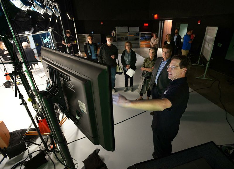 Kris Katrosh (right), media production manager for the University of Arkansas Global Campus, leads a tour April 26 of the studio space inside the campus’ newly renovated building in Fayetteville. Improvements to the building, including a new black box theater, were made in support of the university’s online education, which serves a growing percentage of the student population.  a