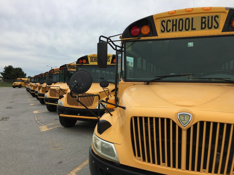 NWA Democrat-Gazette/DAVE PEROZEK School buses sit outside the Bentonville School District's transportation department on Northwest Marquess Drive on Monday. The district plans to buy seven new buses this year for about $665,800 to replace aging buses, according to finance director Janet Schwanhausser.