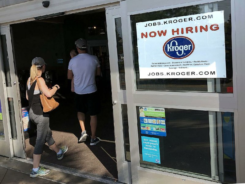 A job openings sign is posted at the front door of a Kroger grocery store Friday in Hilton Head, S.C. Job openings hit a record of 6.7 million in April, the Labor Department reported Tuesday.