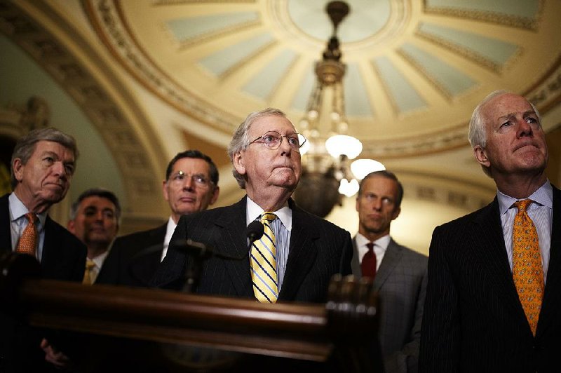 Senate Majority Leader Mitch McConnell (center) cited “the historic obstruction by Senate Democrats of the president’s nominees” and the need to advance spending bills in his announcement that the Senate’s four-week August recess will be shortened to just one week.