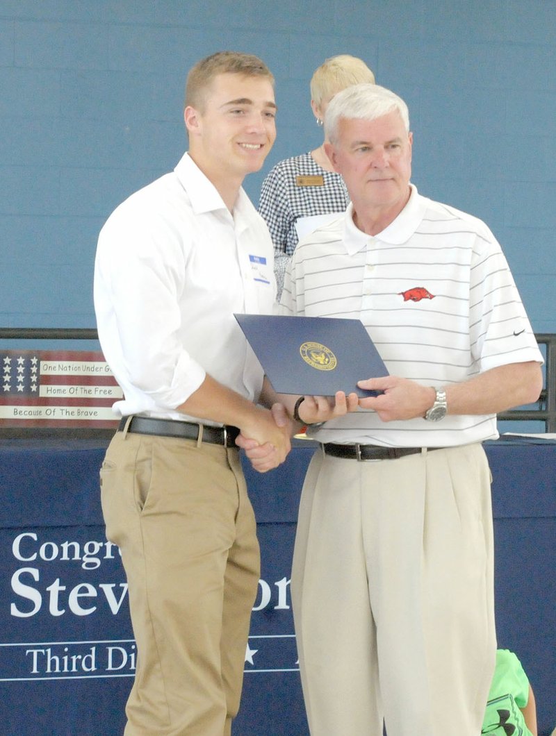 Westside Eagle Observer/MARK HUMPHREY Daniel Huntsman, a 2018 Gravette graduate, shakes hands with Congressman Steve Womack, of Rogers, who gave Huntsman an appointment to the United States Air Force Academy at Colorado Springs, Colo. Womack hosted a sendoff for military service academy appointees and their families Saturday at Springdale's Har-Ber High School cafeteria.