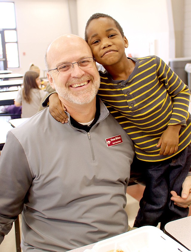 LYNN KUTTER ENTERPRISE-LEADER Malachi Baker, who is in kindergarten at Lincoln Elementary, clowns around with his lunch buddy and mentor, Deon Birkes, assistant principal for Lincoln High School and the district's athletic director.