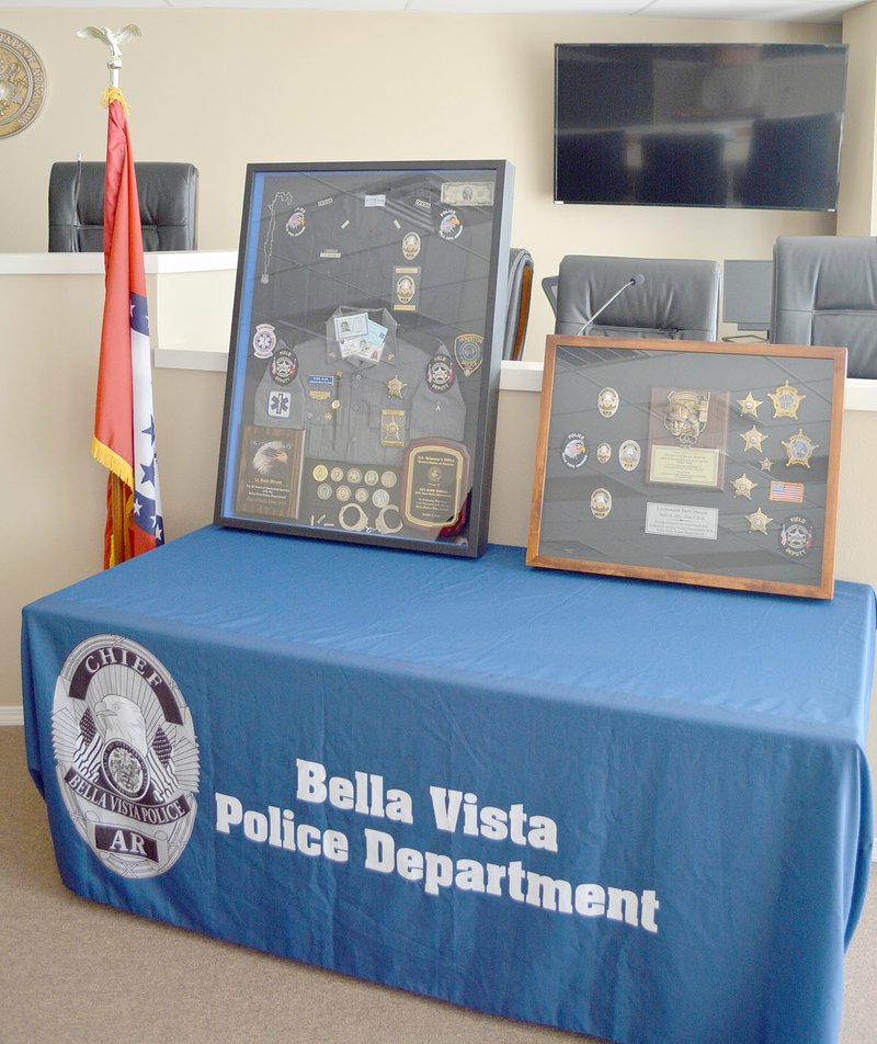 Keith Bryant/The Weekly Vista The Fraternal Order of Police and Bella Vista Police Department both prepared shadowboxes to celebrate Lt. Barb Shrum's retirement.