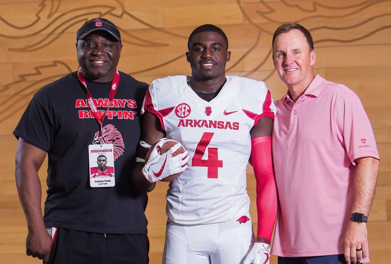 Anthony and Aaron Young with Coach Chad Morris. 