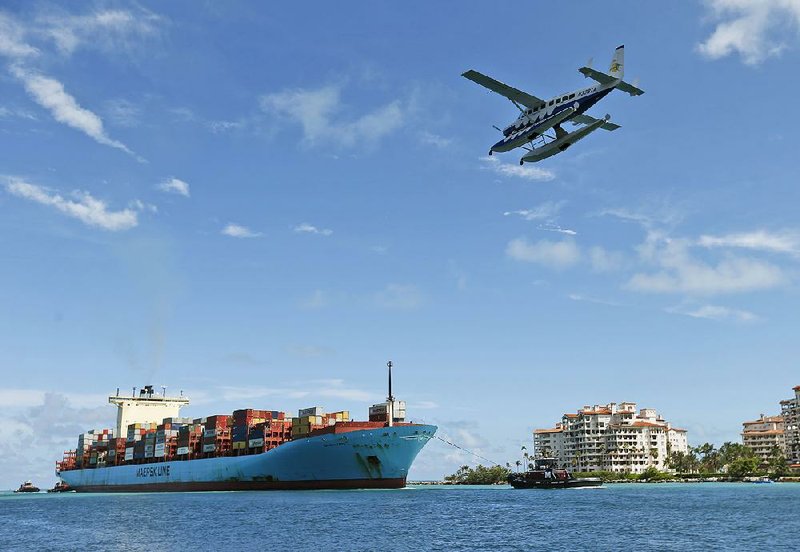 The container ship Gerd Maersk heads to port in Miami Beach, Fla., last month. The U.S. trade deficit is the narrowest since September thanks to record exports, the Commerce Department says. 
