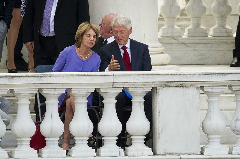 Kathleen Kennedy Townsend, daughter of Robert F. Kennedy, talks with former President Bill Clinton during ceremonies Wednesday at Arlington National Cemetery marking the 50th anniversary of Kennedy’s death.  
