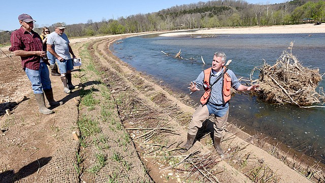 McDonald County Press/FLIP PUTTHOFF Steve Herrington with The Nature Conservancy talks about the Elk River stream bank restoration project completed one mile upstream from Noel, Mo., earlier this year. A bend in the river had severe erosion problems that polluted the stream with silt and caused property owners to lose chunks of land.