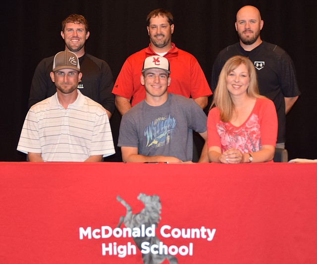 RICK PECK/SPECIAL TO MCDONALD COUNTY PRESS Ty Shaver (seated, center) recently signed a letter of intent to play baseball at Oklahoma Wesleyan University in Bartlesville, Okla. Front row right to left: James Shaver (dad), Ty Shaver and Christina Shaver (mom). Back row: MCHS baseball coaches Kellen Hoover, Nick Martin and Bo Bergen.