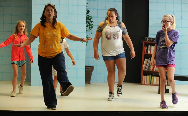  Instructor Jules Taylor works with actors Viola Kelle (from left), Violet Newberry, Kayla Henderson and Ayla Fortin during the "Broadway Bound" theater camp at Arts Live Theater in Fayetteville. The spring break camp in 2017 culminated with a performance. The organization's "Laugh Out Loud Gala" will benefit programming and scholarships for participants.