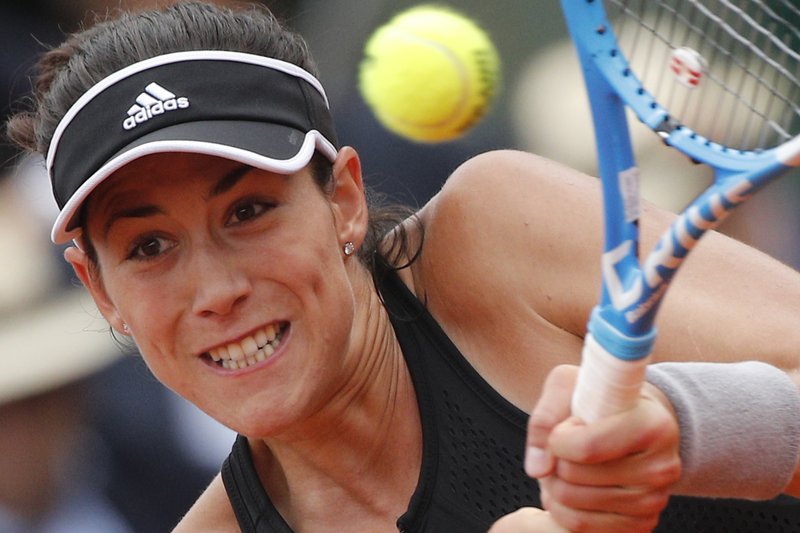 The Associated Press SEMIFINAL BOUND: Spain's Garbine Muguruza returns a shot against Russia's Maria Sharapova during their quarterfinal match of the French Open at Roland Garros in Paris, France, Wednesday.